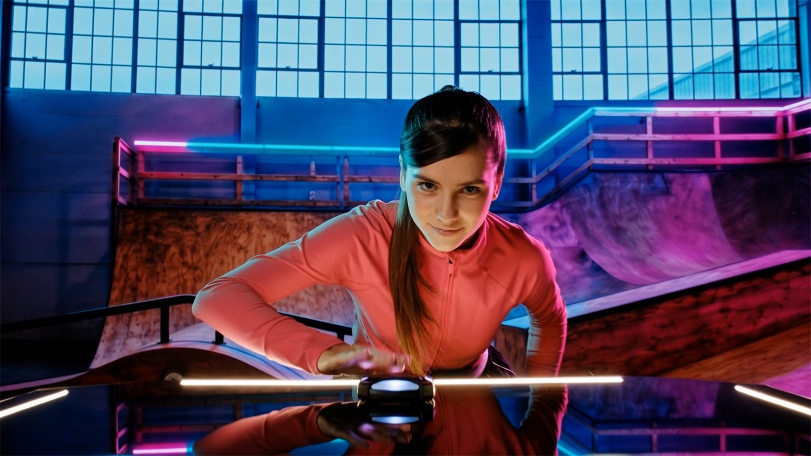 Two players competing at a neon-lit ActivePod arena